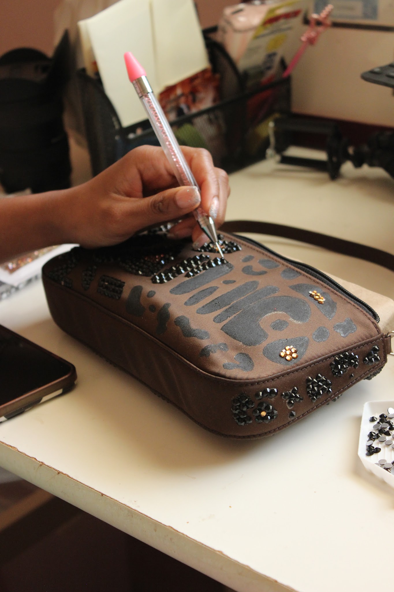 Rhinestones being placed by hand in the Luckie Girl studio